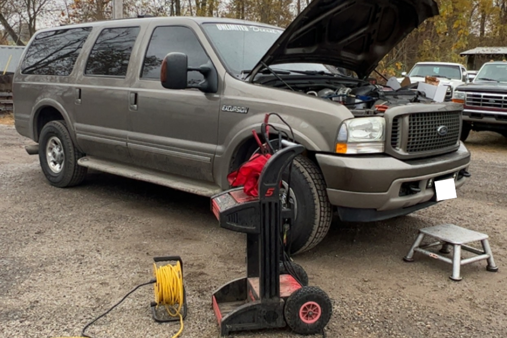 Diesel Truck in Bremen,OH. Unlimited Diesel Performance. Image of a carbon pile battery load tester connected to a vehicle with the hood open, used to test battery strength, cold cranking amps, and alternator charging performance during diagnostics.
